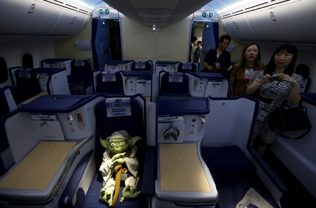 Image #: 40770679    Visitors look at a Yoda plush toy sitting in the business class section during a tour of the "Star Wars"-themed All Nippon Airways ANA R2-D2 Boeing 787 Dreamliner aircraft in Singapore's Changi Airport November 12, 2015. The aircraft was opened to the media on Thursday as it made its first Asian stop outside Japan. REUTERS/Edgar Su  /LANDOV